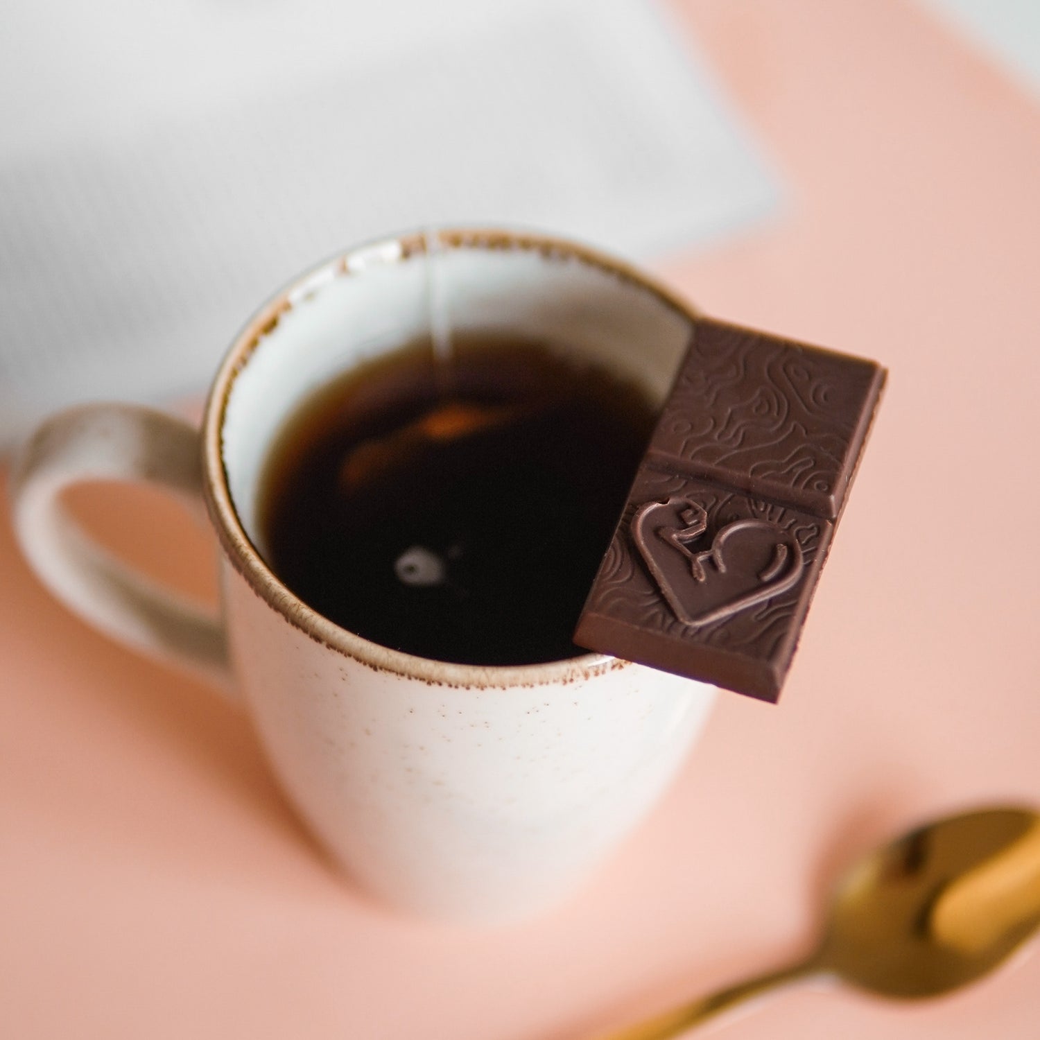 chocolate squares funky fat foods resting on tea mug